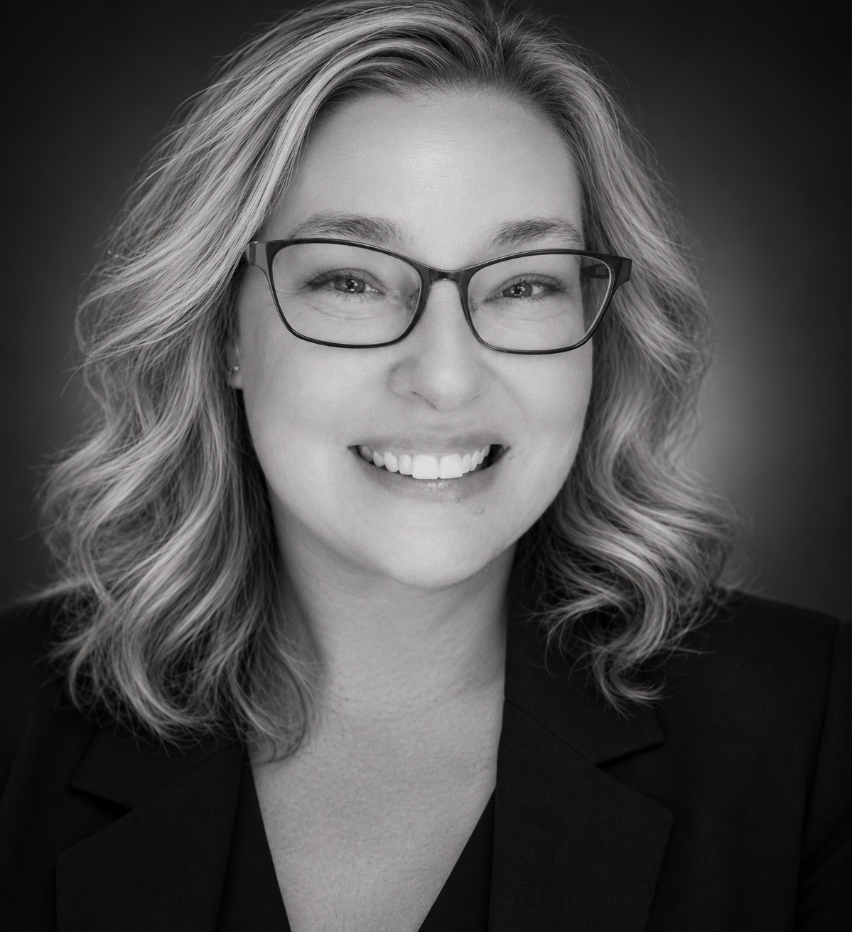 Black-and-white professional portrait of Amy Matthew, founder of Reflected Lyrical Productions