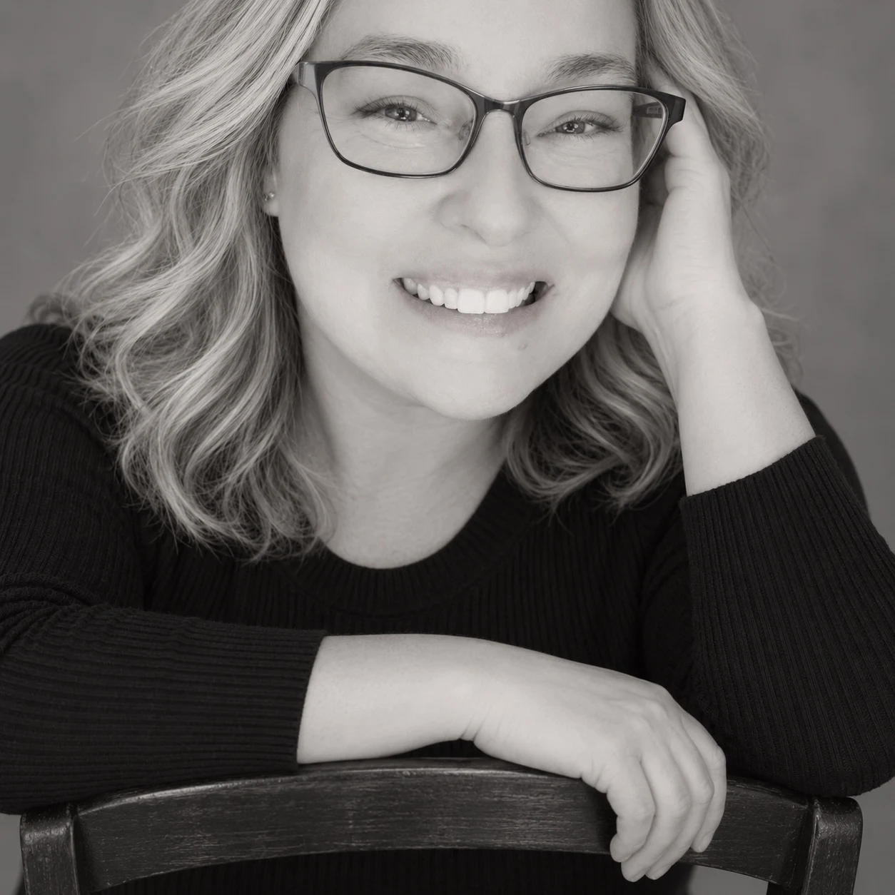 Amy Matthew seated at a chair